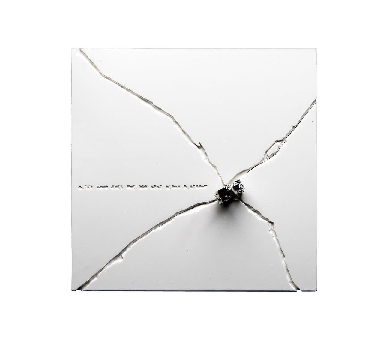 White fractured piece and presentation box, primary view
